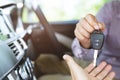 Car key, businessman handing over gives the car key to the other man in car interior Royalty Free Stock Photo