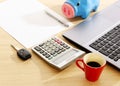 Car key and calculator with office supplies on wood table desk Royalty Free Stock Photo