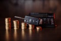 Car key and coins on wooden background, concept photo for car finance industry Royalty Free Stock Photo