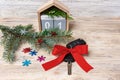 Car key with colorful bow and calendar, christmas tree, branches, snowflakes, on wooden background Royalty Free Stock Photo