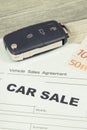 Car key, euro banknotes and form of vehicle sales agreement. Inscription car sale. Sales and buying new or used car Royalty Free Stock Photo