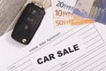 Car key, euro banknotes and vehicle sales agreement. Inscription car sale. Sales and buying new or used car Royalty Free Stock Photo