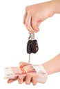 Car key in hand and cash money Royalty Free Stock Photo