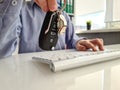 Car key in hand keyboard posk transport on internet Royalty Free Stock Photo