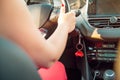 Car key in ignition. Start, stop or accelerate engine. Car shape keyfob on vehicle dashboard background during driving. Woman Royalty Free Stock Photo