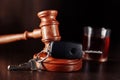 Car key, judge gavel and bottle of alcohol with glass close-up. Drunk driving concept Royalty Free Stock Photo