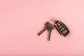 Car key with key fob on a colored background.