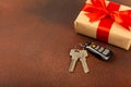 Car key with key fob on a colored background.