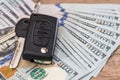 Car key lying on US 100 dollar bills Royalty Free Stock Photo