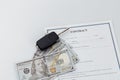 Car key, money and contract on a table. Car purchase or insurance concept Royalty Free Stock Photo