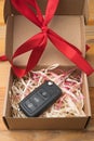 Car key in a paper box with red bow Royalty Free Stock Photo