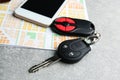 Car key, phone and map on table Royalty Free Stock Photo