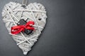 Car key with red bow on a wooden heart Royalty Free Stock Photo