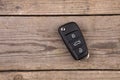 Car key with remote alarm control on the wooden desk Royalty Free Stock Photo