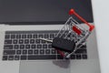 Car key in shopping trolley on a laptop keyboard Royalty Free Stock Photo