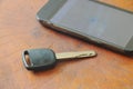 Car key and smart phone opened map on table Royalty Free Stock Photo