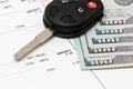 Car key, vehicle warranty repair bill and 100 dollar bills cash