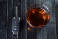 Car key and whiskey in a glass on black wooden table. Don`t drink and drive abstract concept Royalty Free Stock Photo