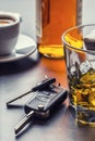 Car keys and glass of alcohol on table. Royalty Free Stock Photo