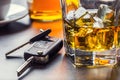 Car keys and glass of alcohol on table. Royalty Free Stock Photo