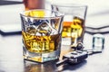 Car keys and glass of alcohol on table in pub or restaurant Royalty Free Stock Photo