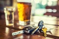 Car keys and glass of beer or distillate alcohol on table in pub or restaurant Royalty Free Stock Photo