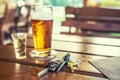 Car keys and glass of beer or distillate alcohol on table in pub or restaurant Royalty Free Stock Photo
