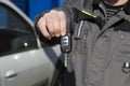 Car keys in the hands of a car mechanic.Car maintenance