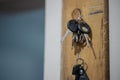 Car keys hanging on a wooden holder. Collection of keys ready to be taken