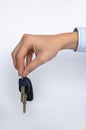 Car keys in a man`s hand, on a white background