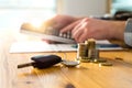 Car keys and money on table with man using calculator. Royalty Free Stock Photo