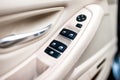 Car leather interior details of door handle with windows control Royalty Free Stock Photo