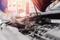 Car on lift, auto mechanic working in service garage