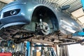 Car on the lift at auto repair garage Royalty Free Stock Photo