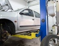 Car on a lift, front wheel removed, service.Car service