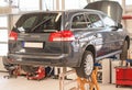 Car on lift in garage. Royalty Free Stock Photo