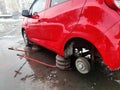 Car with rear wheel removed, lifted by hydraulic jack, car repair on the roadside Royalty Free Stock Photo