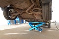 Car lifted by pneumatic jack isolated