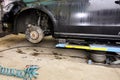 The car lifted by a pneumatic jack, wheel replacement