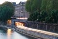 Car light trails at a tunnel exit on the river Seine borders in Royalty Free Stock Photo
