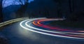 Car lights at dusk on a mountain road, Euskadi