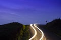 Car lights on mountain road at sunset sky, Aiako Harriak Natural Park, Euskadi Royalty Free Stock Photo