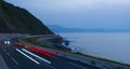 Car lights on the road at dusk by the sea, Euskadi Royalty Free Stock Photo