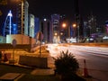 Car lights streak across the citscape of Doha, Qatar