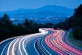 Car lights at sunset driving at high speed on the highway, San Sebastian, Euskadi Royalty Free Stock Photo