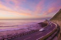 Car lights at sunset by the sea Royalty Free Stock Photo