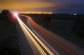 Car lights trails at night on the road.