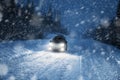 Car lights in winter forest Royalty Free Stock Photo