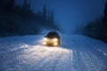 Car lights in winter forest Royalty Free Stock Photo