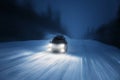 Car lights in winter forest Royalty Free Stock Photo